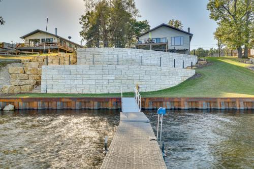 a dock in the water with a house in the background at Dock and Views Waterfront Home in Wabasha! in Wabasha