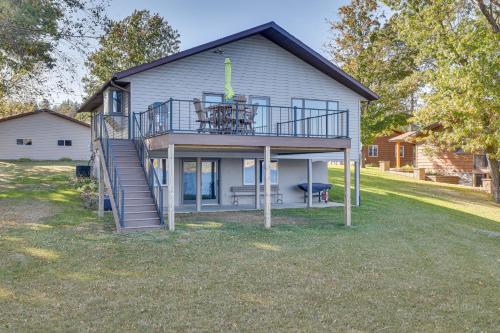 a house with a deck and a balcony at Dock and Views Waterfront Home in Wabasha! in Wabasha
