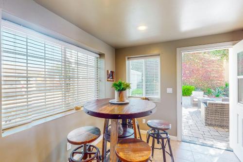 a dining room with a table and stools and windows at Guglielmo Winery Casetta in Morgan Hill