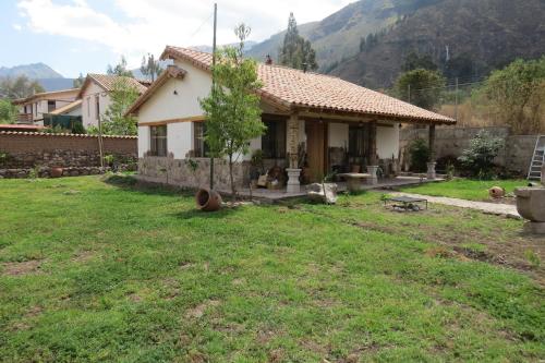 a small house in a field with a yard at casa de campo-arin in Huaran