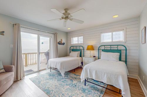 a bedroom with two beds and a balcony at Captiva by Meyer Vacation Rentals in Gulf Shores