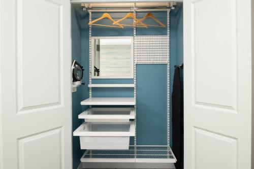 a walk in closet with blue walls and white doors at TownePlace Suites by Marriott Eugene in Eugene