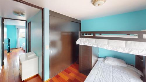 a bedroom with two bunk beds and a mirror at Bello departamento en Centro Histórico de la CDMX in Mexico City