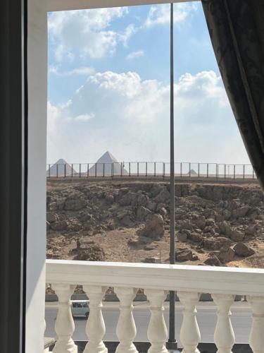 a view of the beach from a balcony of a building at Pyramids Panorama Suites in ‘Ezbet `Abd el-Ḥamîd
