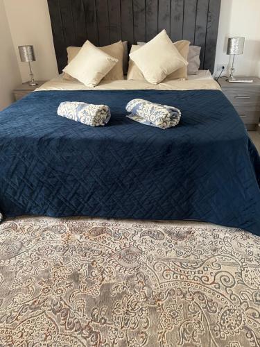 a bed with two pillows on top of it at Pyramids Panorama Suites in ‘Ezbet `Abd el-Ḥamîd