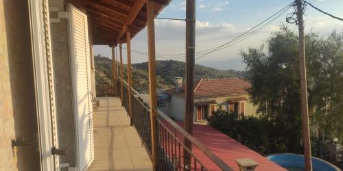 a balcony with a view of a house at Koufos House in Sparti
