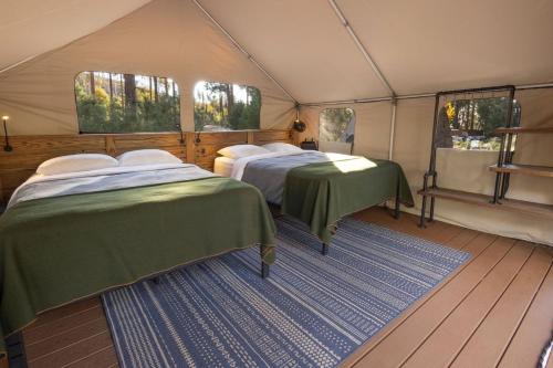 a room with two beds in a tent at Evergreen Lodge at Yosemite in Groveland