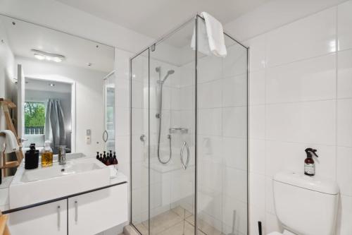 a bathroom with a shower and a toilet and a sink at Edge of Heaven in Wanaka