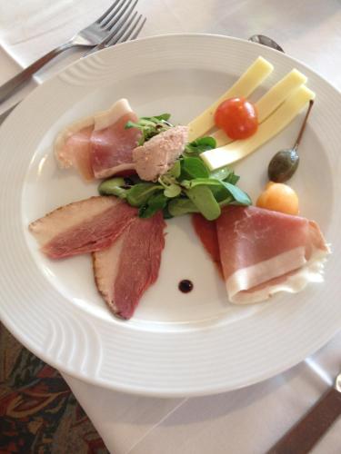 a plate of food with meat and vegetables on it at Gostisce Golob in Zgornja Polskava