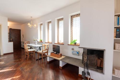 a living room with a table and a fireplace at Terrazza dei fiori in Cesano