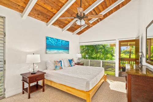 a bedroom with a bed and a ceiling fan at Beautiful 2 Br 2.5 Ba Condo Golf Course View, Pool, Hot Tub (209AB) in Princeville