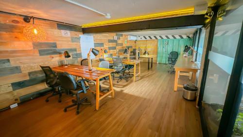 a room with tables and chairs and a brick wall at Mayan Monkey Cancun - Social Hotel in Cancún