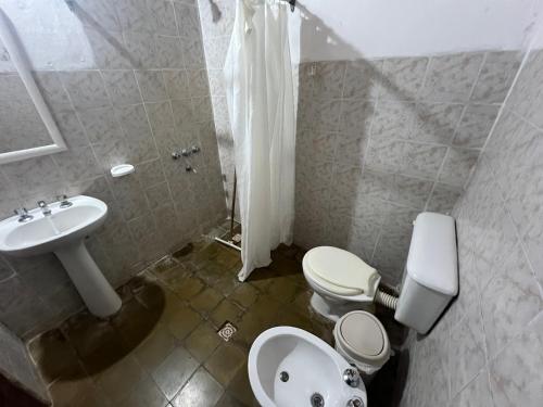a bathroom with a toilet and a sink at Posada el Yacaré in Colonia Carlos Pellegrini