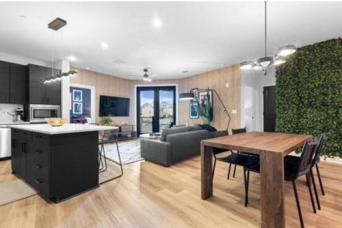 a kitchen and living room with a table and a couch at Electric - Odyssey -Top Floor West End 2 Bedroom - Minutes to Broadway in Nashville