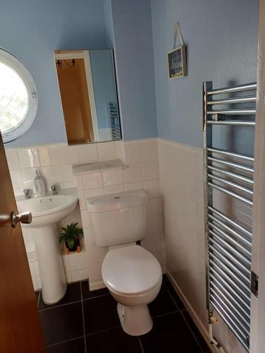 a small bathroom with a toilet and a sink at Cental Retreat - 2 bedroom apartment in Belfast