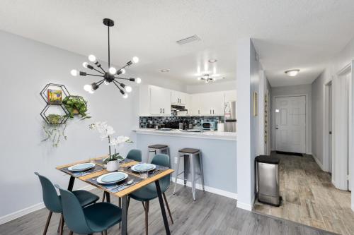 a dining room and kitchen with a table and chairs at Oasis 219 - Amalfi Allure in Titusville