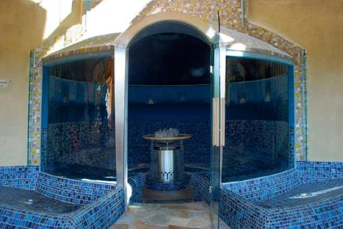 a blue tiled bathroom with a fountain in the middle at Lassacher Biobauernhof in Mariapfarr