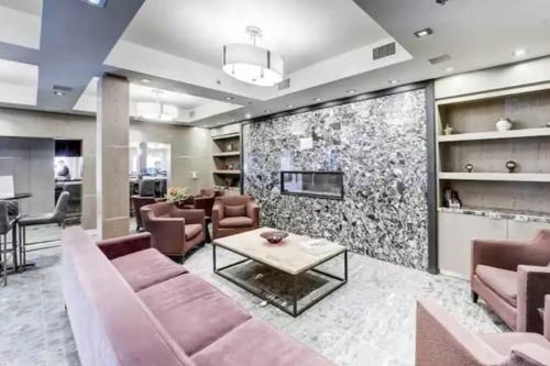 a living room with a couch and a fireplace at Mountain Getaway in Canmore - Sleeps 6 - Pool & Hottub in Canmore