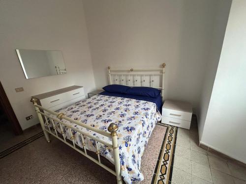 a bedroom with a bed and a dresser and a mirror at Odissea Apartment in Nettuno