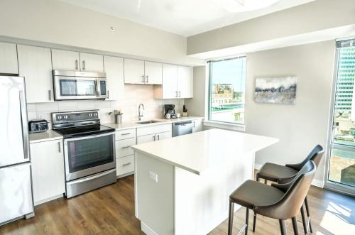 a kitchen with white cabinets and a white counter top at Entire Apt Downtown with Gym in Stamford