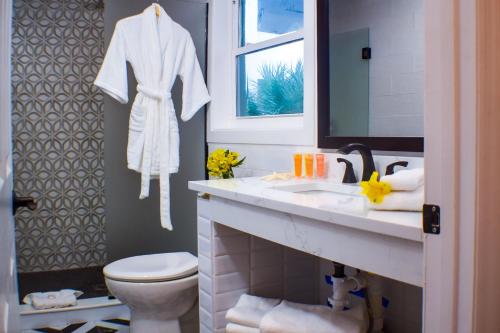 a bathroom with a sink and a toilet and a mirror at Devon Shores in Clearwater Beach
