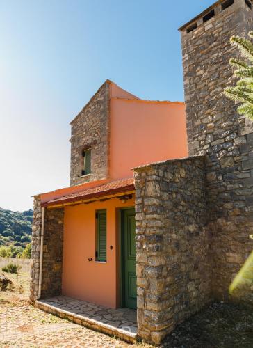 an orange and green building with a green door at Kalavryta Estate Villa in Kalavrita