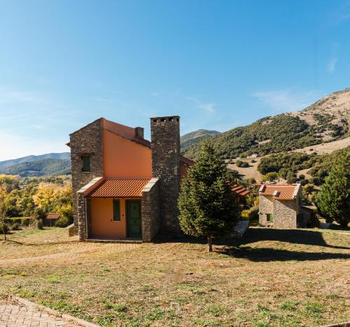 a view of a house with a mountain in the background at Kalavryta Estate Villa in Kalavrita