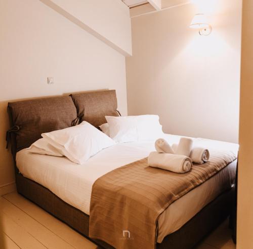 a bedroom with a bed with two towels on it at Kalavryta Estate Villa in Kalavrita