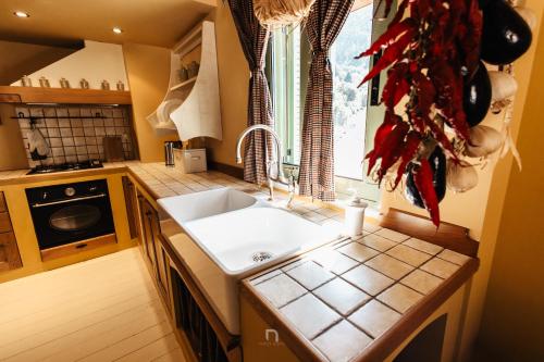 a kitchen with a white sink and a window at Kalavryta Estate Villa in Kalavrita