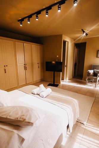 a bedroom with a large bed with towels on it at Kalavryta Estate Villa in Kalavrita