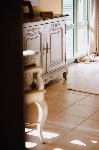 a white cabinet in a room with a tile floor at Kalavryta Estate Villa in Kalavrita