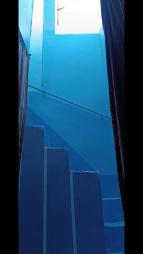 an empty room with blue stairs and a window at محافظه اسوان جزيره اسوان النجع البحرى in Aswan