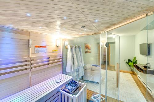a sauna with a glass wall in a room at Spacious Old Forge Condo w/ Patio & Fire Pit! in Old Forge