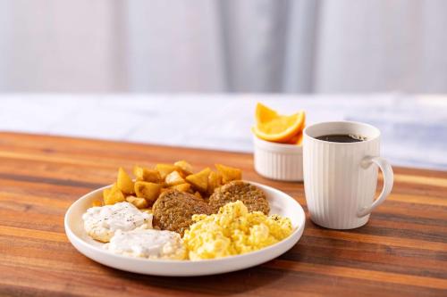 a plate of breakfast food and a cup of coffee at Drury Inn & Suites Memphis Southaven in Horn Lake