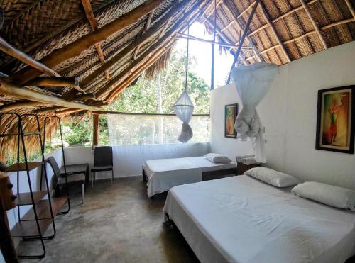 Llit o llits en una habitació de Hotel Jasayma dentro del Parque Tayrona