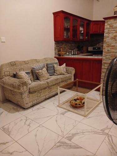 a living room with a couch and a table at Wild Blue Lodge in Gwa Kay