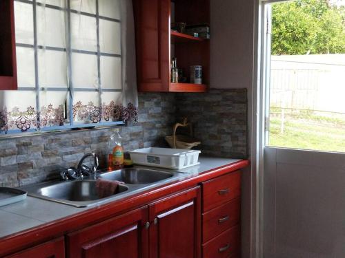 a kitchen with a sink and a window at Wild Blue Lodge in Gwa Kay