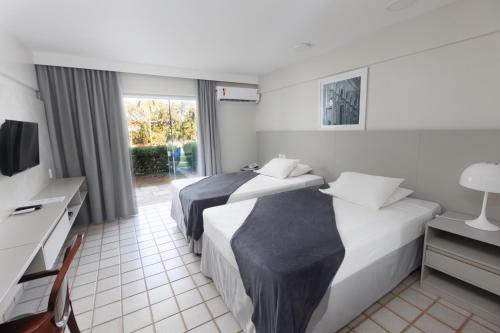 a hotel room with two beds and a television at Blue Tree Premium São Luis in São Luís