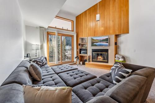 a living room with a large couch and a fireplace at Keystone Retreat with Resort Amenities in Keystone