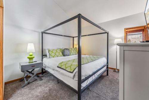 a bedroom with a black canopy bed and a table at Keystone Retreat with Resort Amenities in Keystone