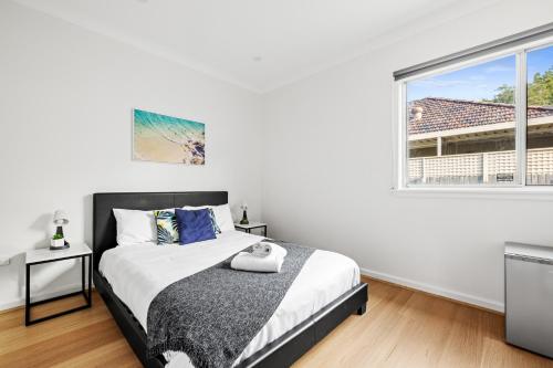 a bedroom with a bed and a large window at Elegant Queen Room at Botany - Nearby Airport - Shared Bathroom in Sydney