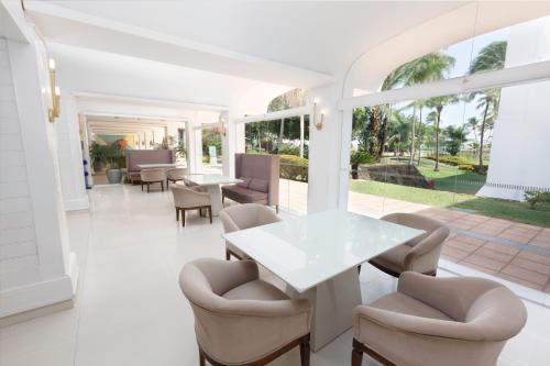 a white dining room with a white table and chairs at Blue Tree Premium São Luis in São Luís