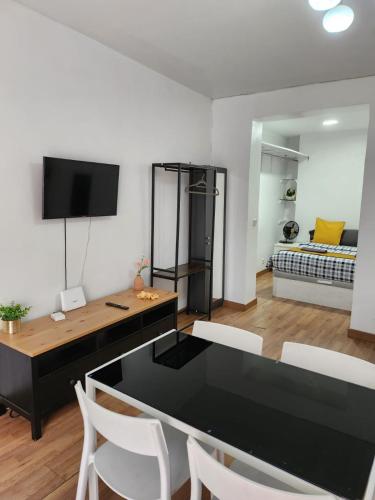 a living room with a black table and white chairs at Estudio 504 M-15 in Madrid