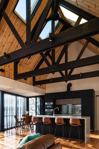 a living room with wooden ceilings and a table and chairs at Deviot Boat House in Deviot