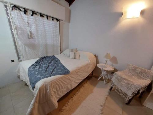 a bedroom with a bed and a window at Casa alquiler temporario miramar in Miramar