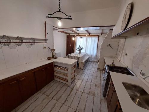 a large kitchen with a table and a stove at Casa alquiler temporario miramar in Miramar