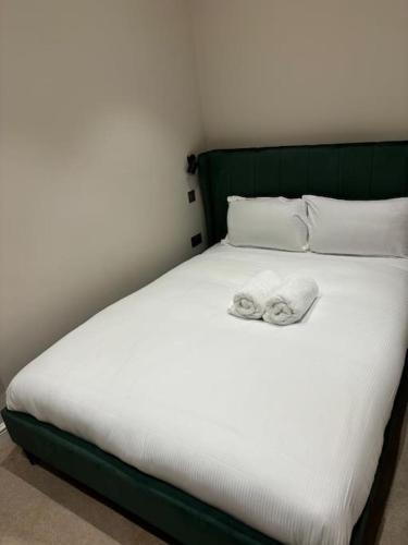 a bed with two towels on top of it at Central Leeds - 2 Bed Ensuite in Leeds