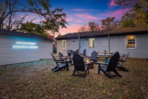 a group of chairs and a table in front of a house at Game Room and Huge Yard with Fire Pit Yard Games and BBQ Near UE and Downtown in Evansville