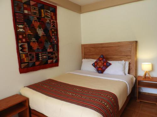 a bedroom with a bed with a pillow on it at Ayllu B&B Ollantaytambo in Ollantaytambo