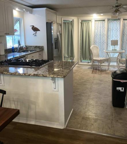 a kitchen with a counter top and a dining room at Dozing on Dog River- River Access Dock Yard in Tillmans Corner